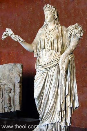 The goddess Demeter (Roman Ceres) stands holding a sheaf of wheat (or fillets) in one hand and cornucopia (horn of plenty) brimming with fruit in the other. She is crowned with a wreath of fruit.
